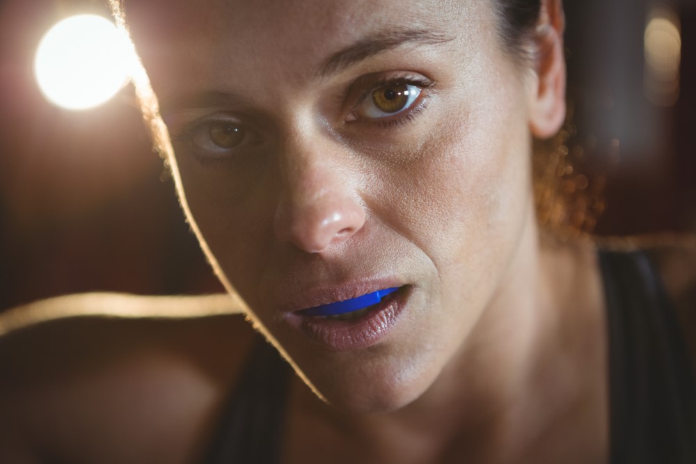 female wearing mouthguard