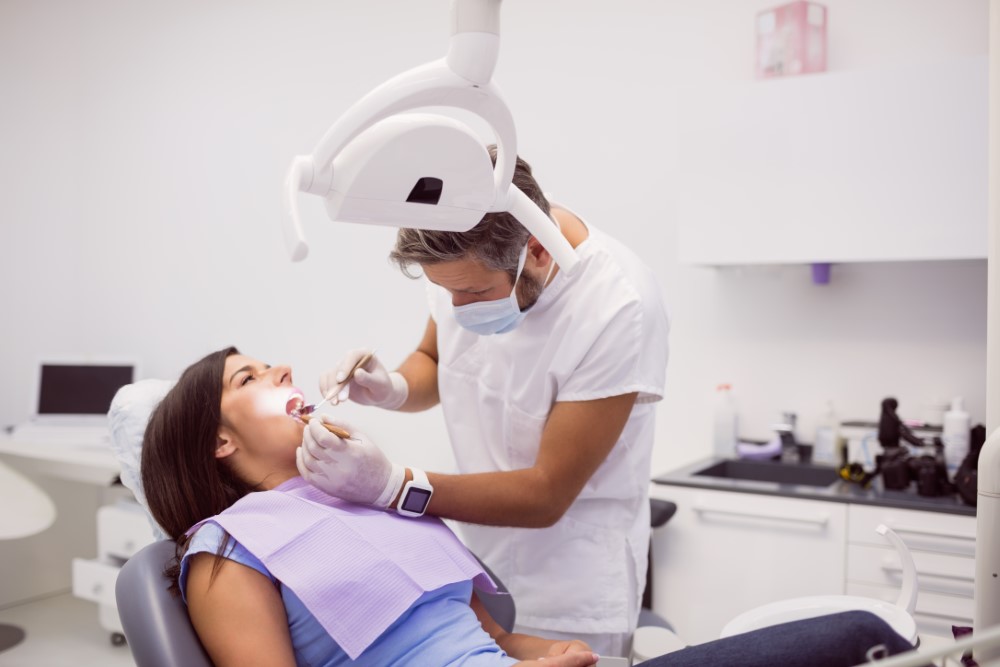 dentist-examining-female-patient-teeth