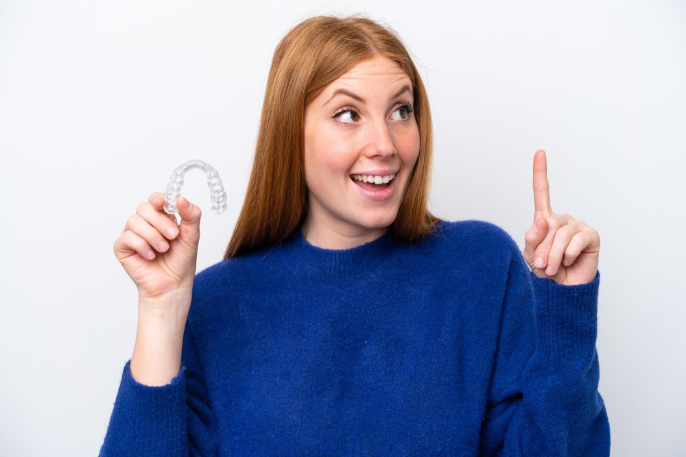 woman holding invisalign